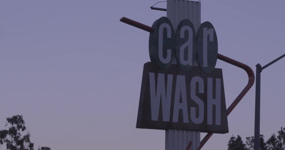 Close up of a car wash sign on a cloudy day