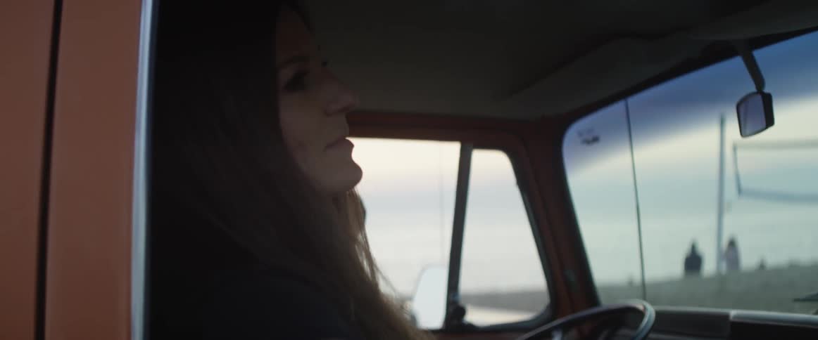 Man and woman travel in a vehicle in the country