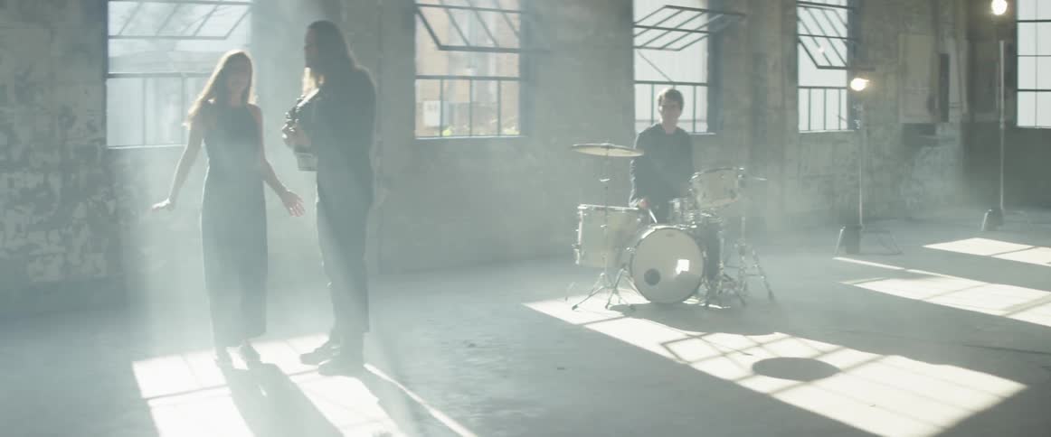 Men and woman play and sing in a band