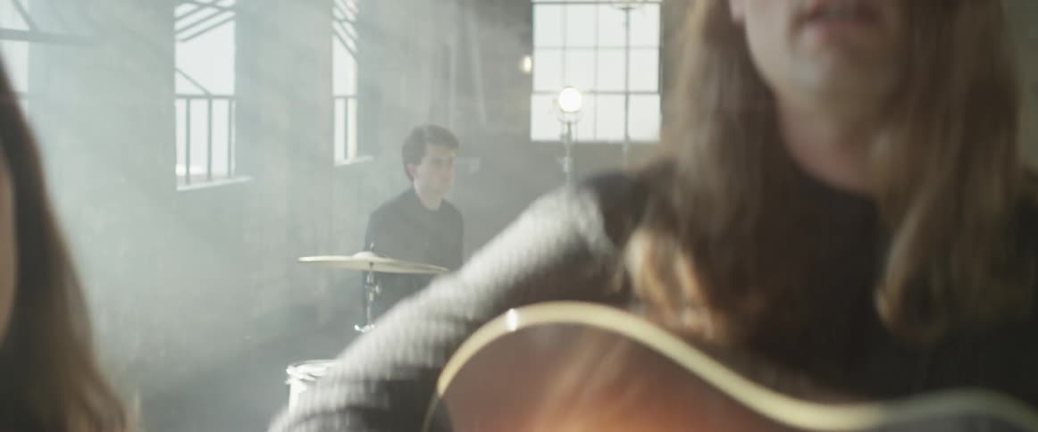 People are performing with musical instruments in the room