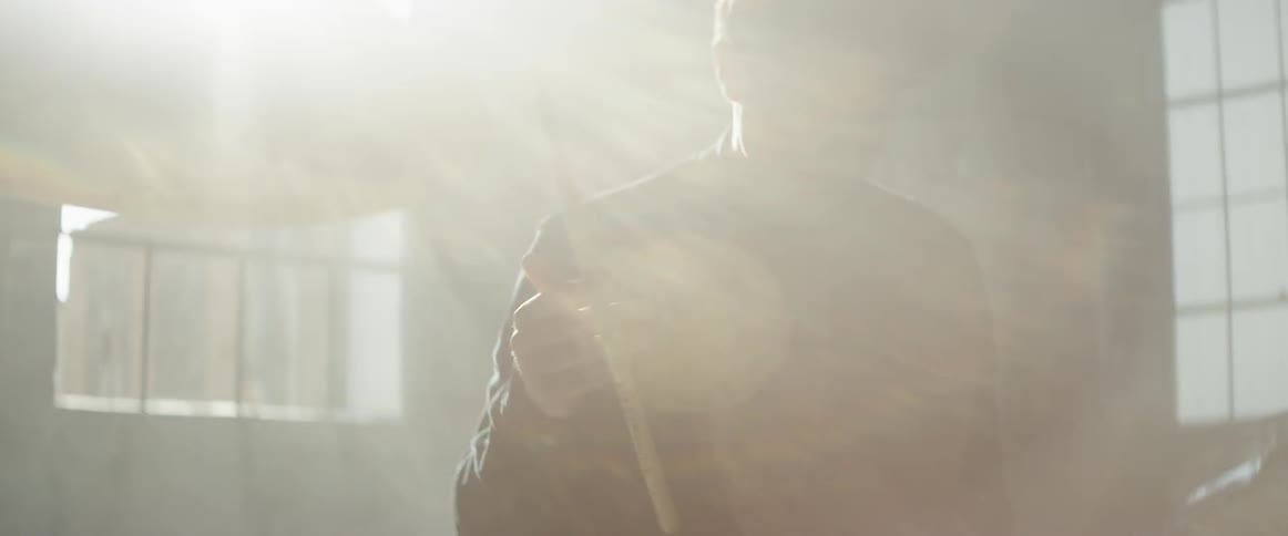 The man is playing the drums by the window