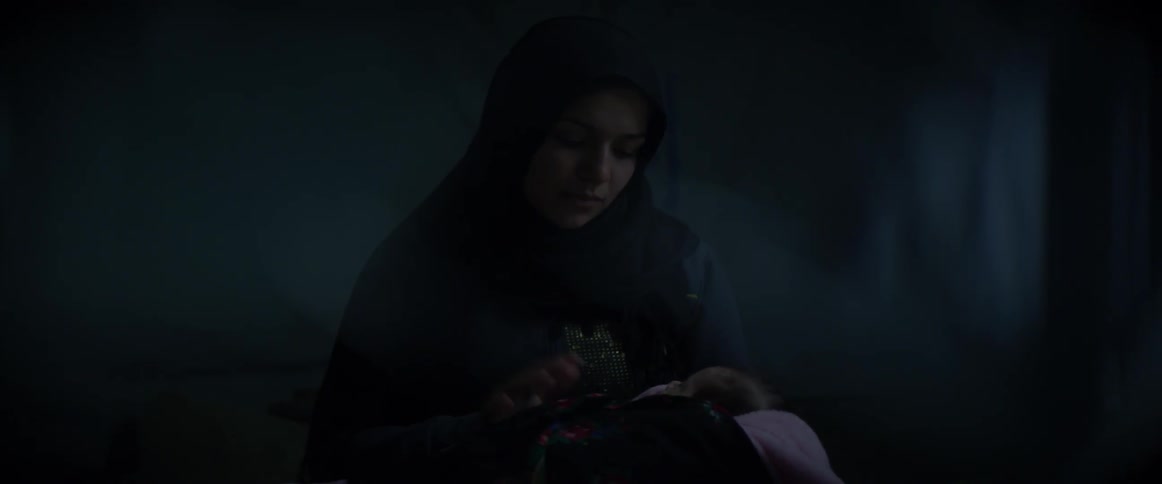 A woman rocks and comforts her baby