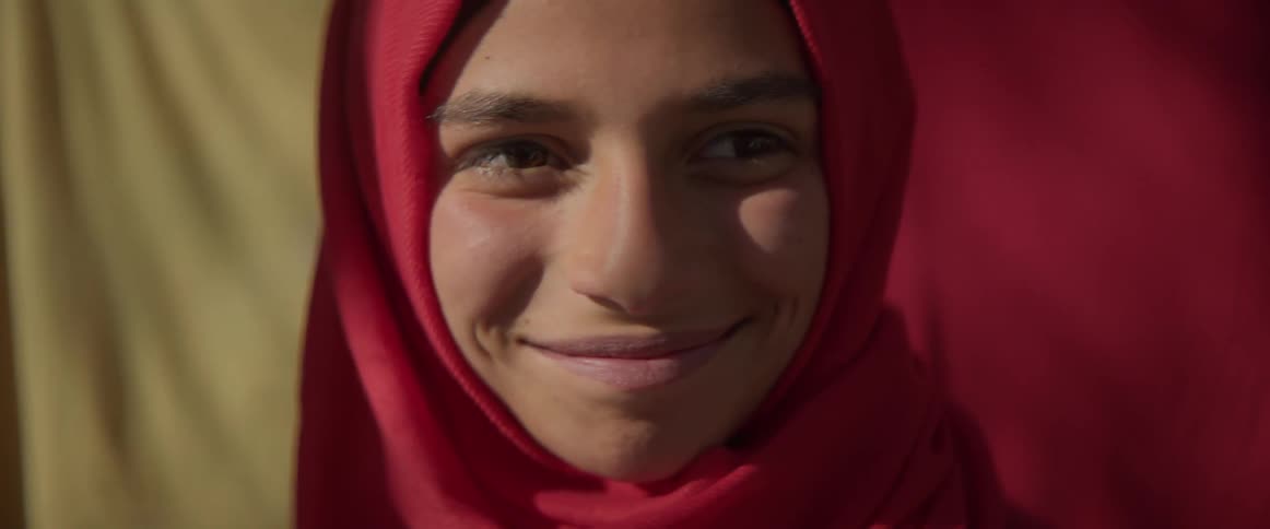 Girl smiles outside on a sunny day