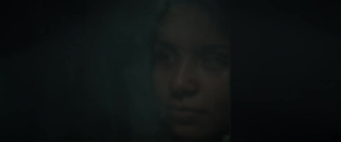 A woman looks at her reflection in a mirror