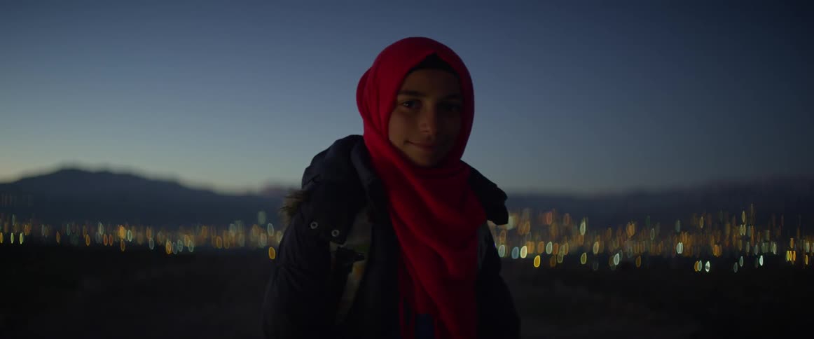 A woman smiles as she looks to the side