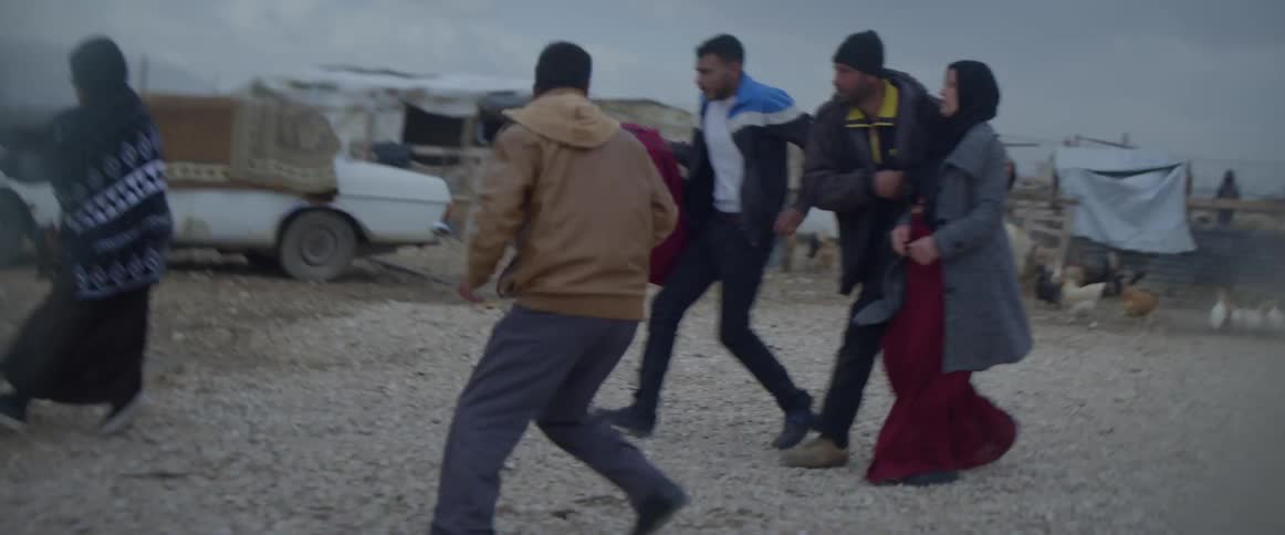 Group of people run towards a van