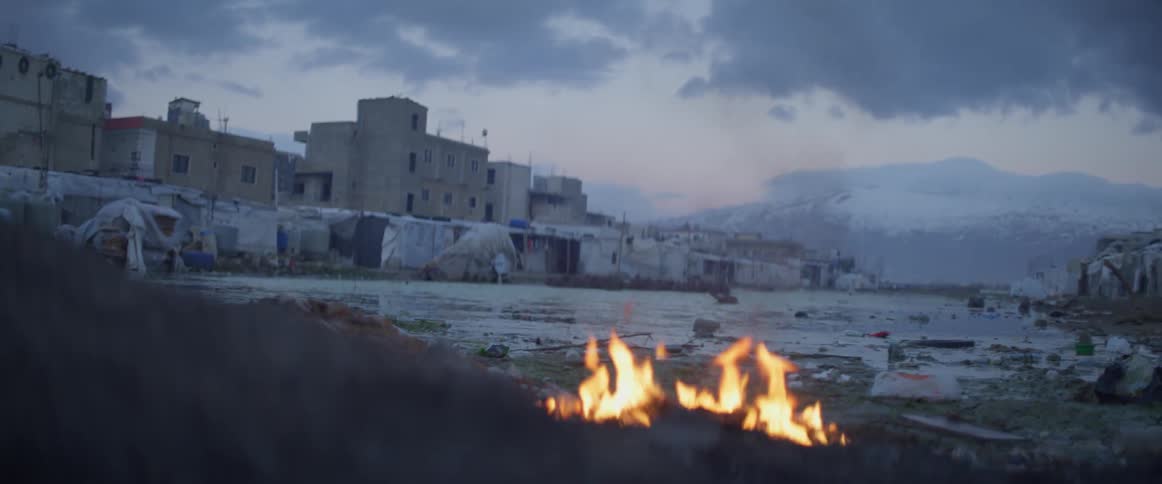 Fire crackles outside near a small village