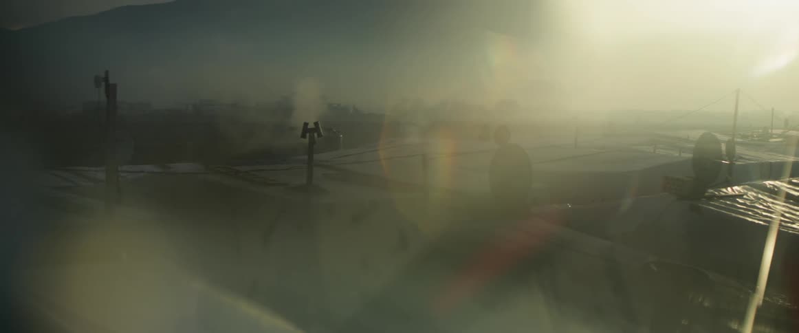 Rooftop of a building in a city on a foggy day