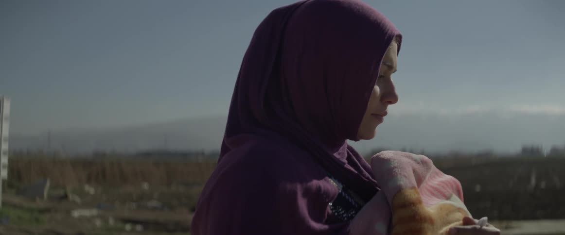 A woman in a burka walks outside