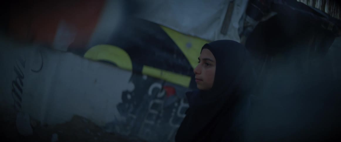 A woman in a burka walks outside