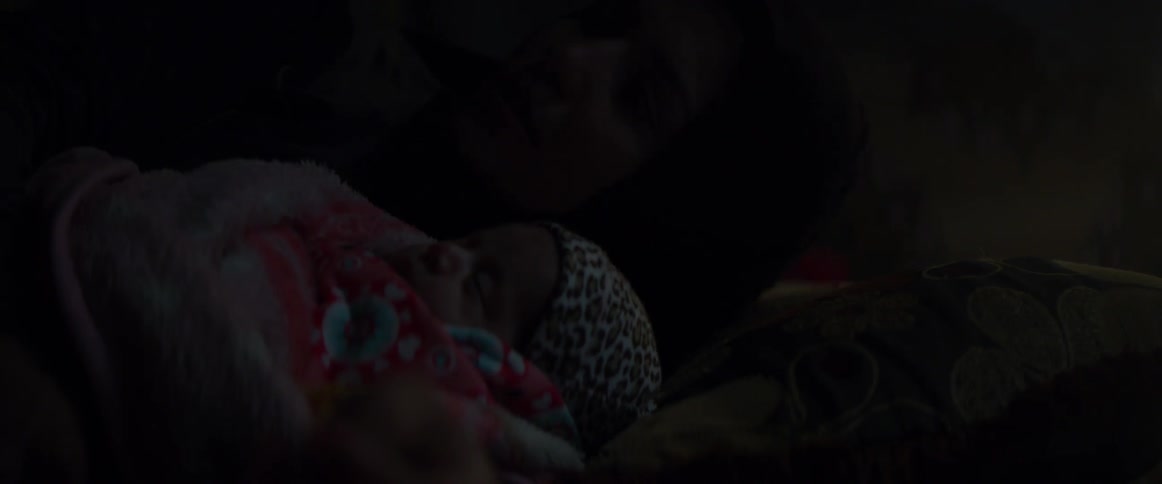 Baby sleeps while wrapped in a blanket