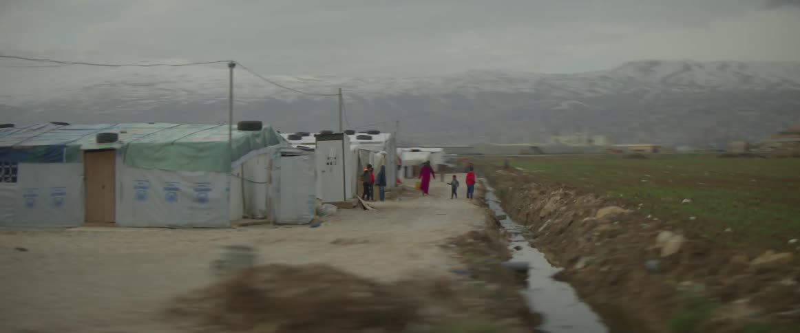 People walking around outside a village in the country