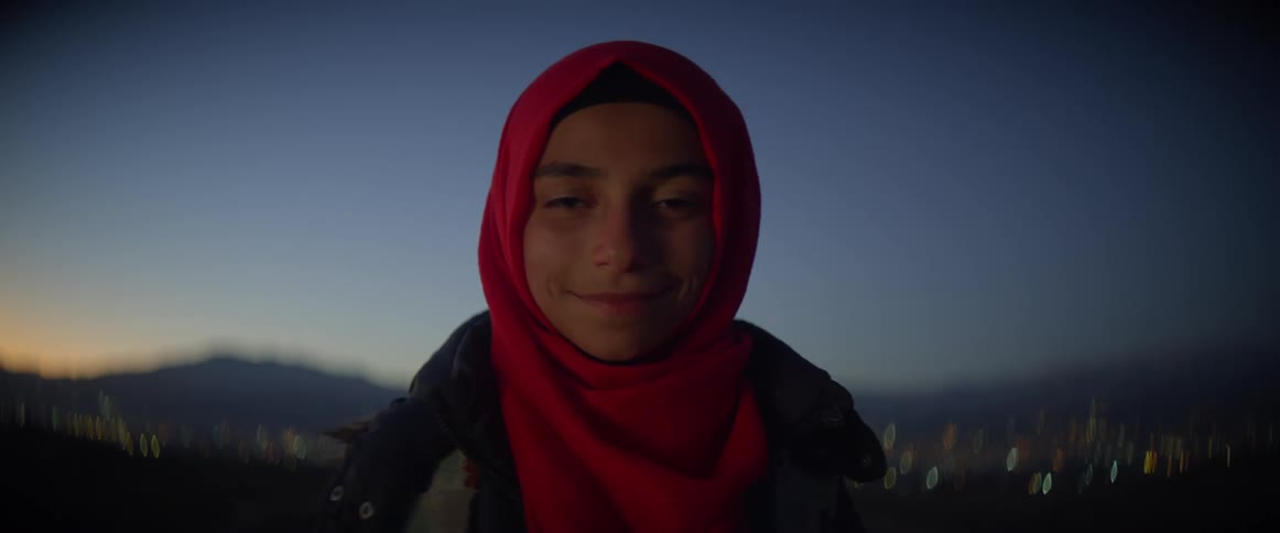 Woman wearing a red scarf blinks as she smiles
