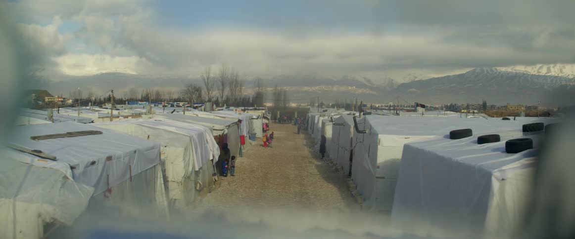 Rows of white tents in a small village