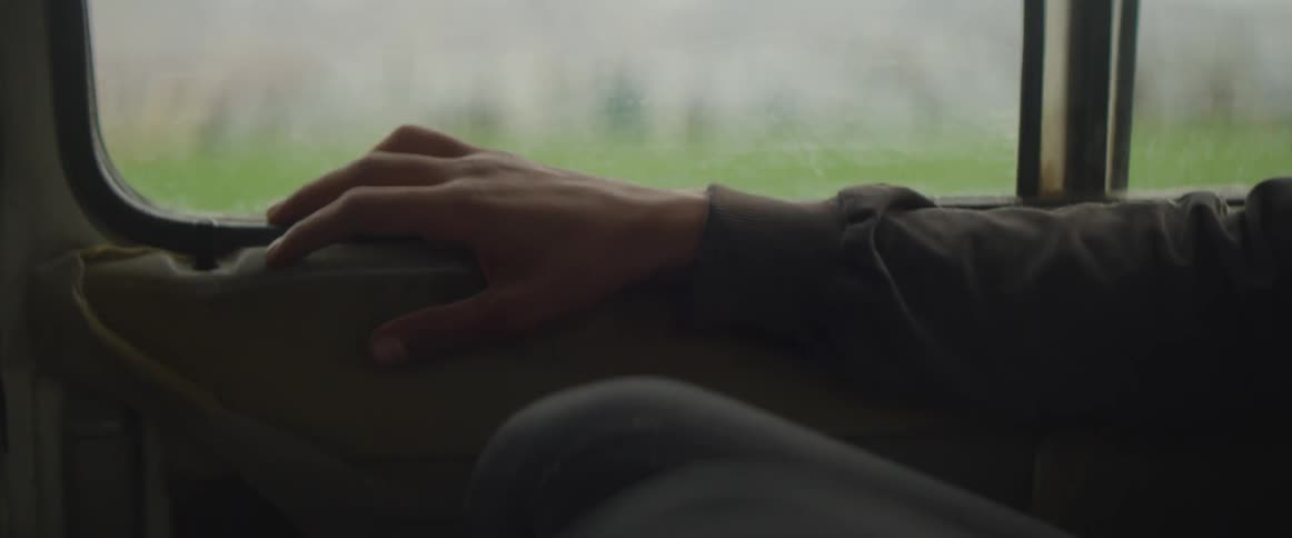 A person is tapping their fingers in the car