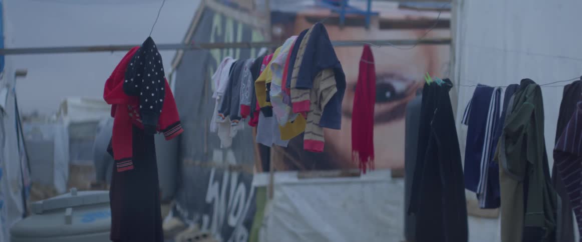 Lines of clothing hanging outside near tents