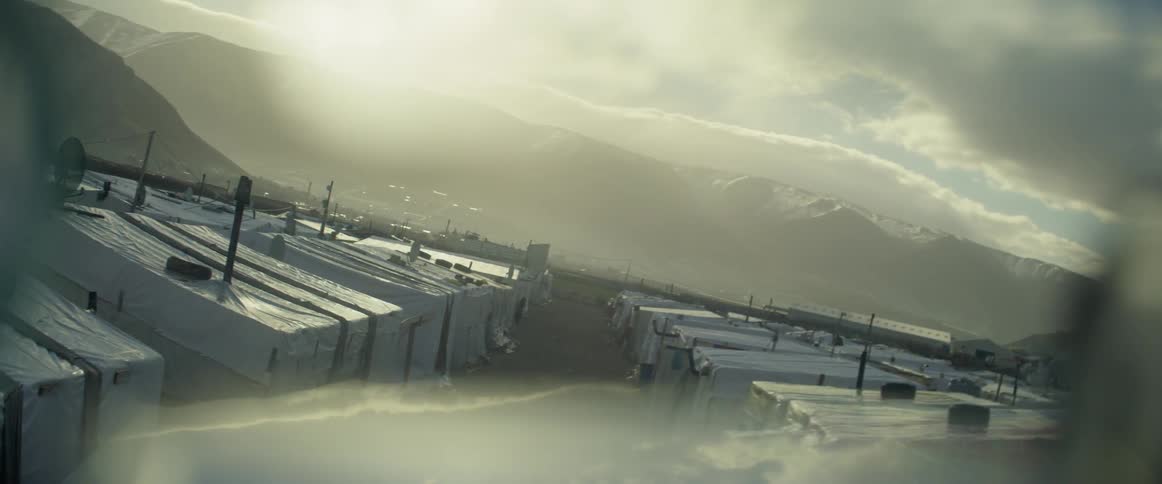 Sun shines over rows of tents in a village