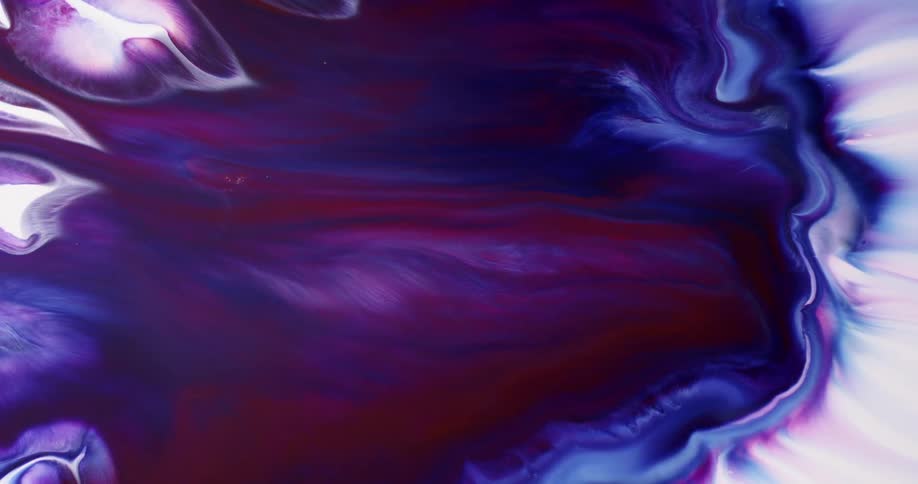 Different colors of liquid swirl and drift apart