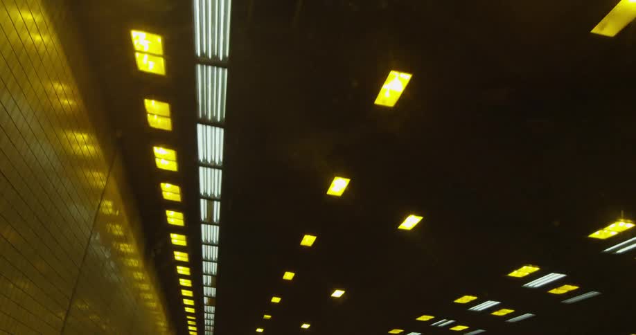 Ceiling of a tunnel with many lights blinking