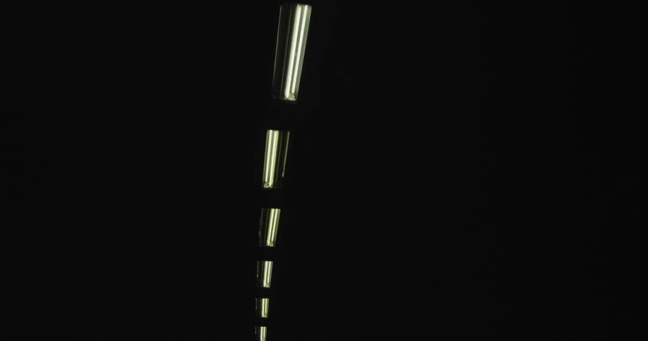 View of a dark ceiling with a single string of lights