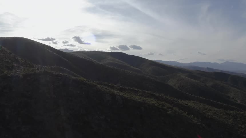 The bright sun shines on the rolling hills