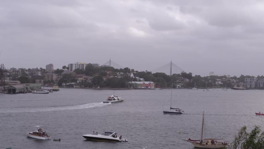 Boats floating on water near a city