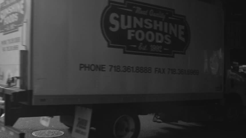 Truck driving underneath a tunnel on a street