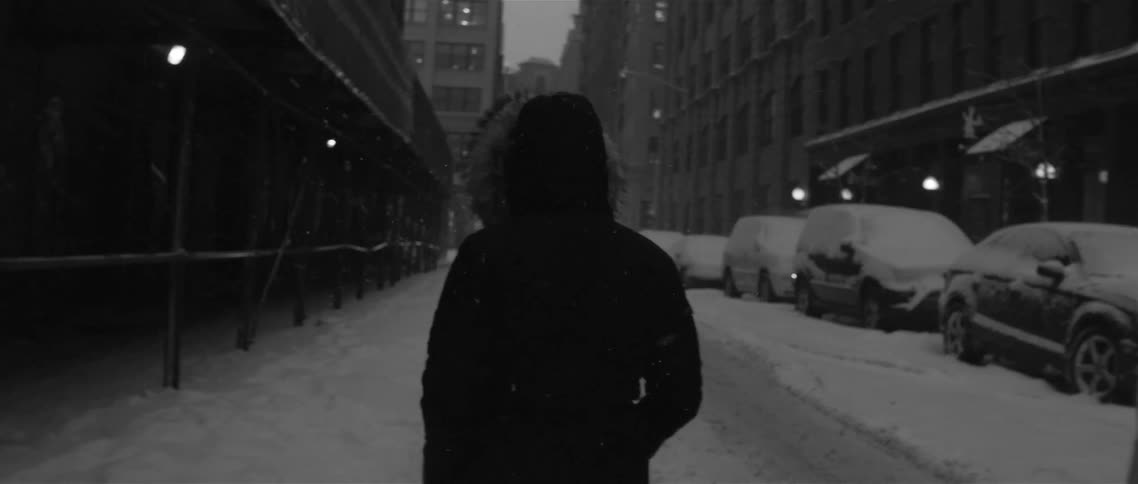Person walking down a snowy city street