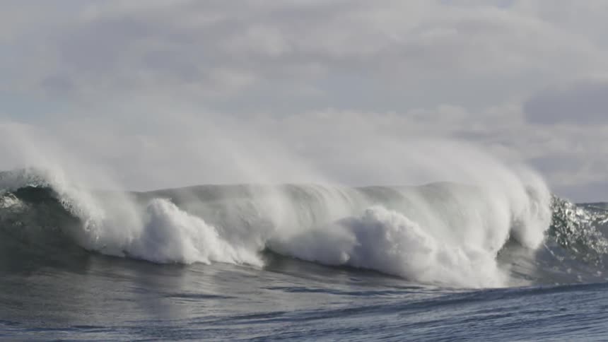 Large waves crash on a cloudy day