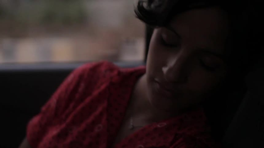 A person sleeping inside of a car