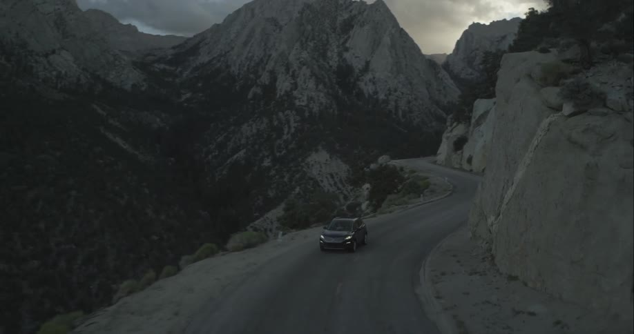 Vehicle driving down a cliffside road
