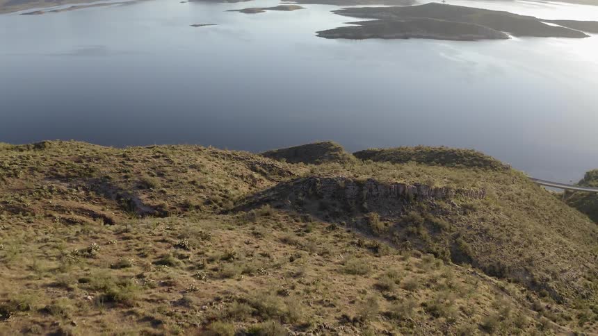 A calm lake sits at the base of the hills