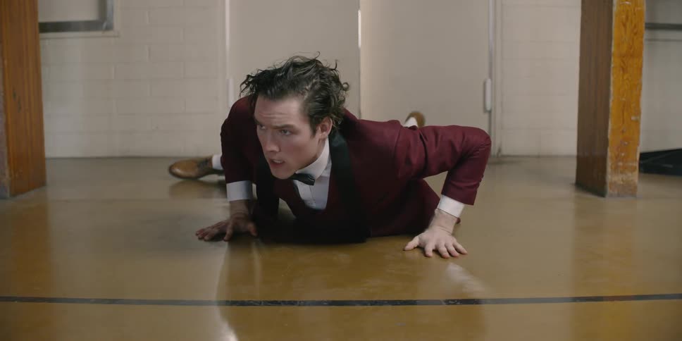 A man enters through the door and falls over