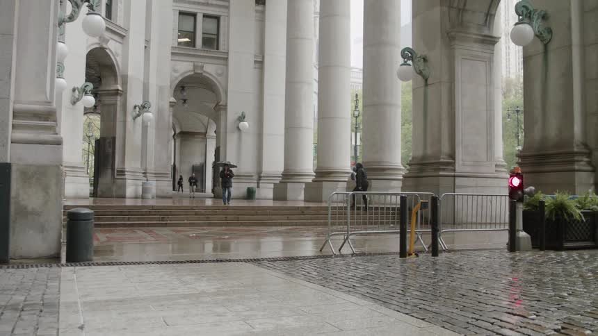 People walk past the building ahead