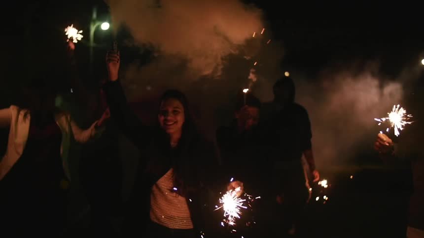 A group of people holding sparklers