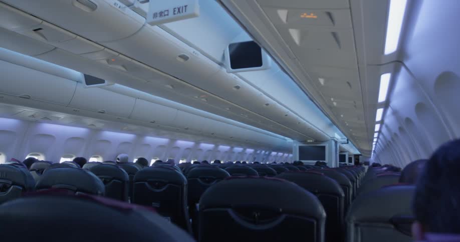 People sit in their seats in a jetliner