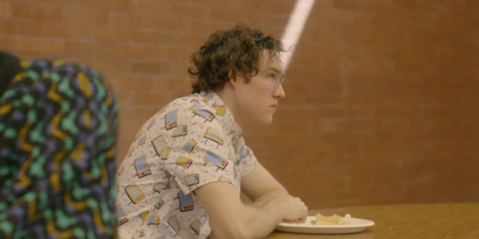 Man sits at a cafeteria table
