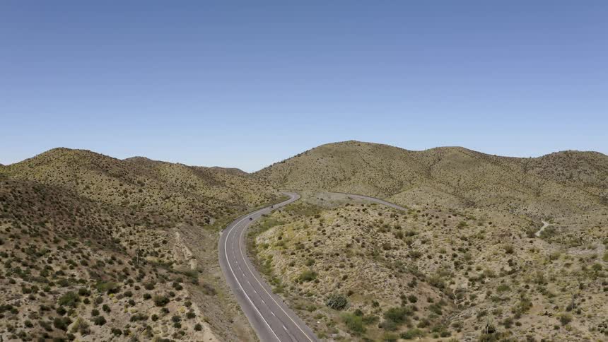 Vehicles travel down a mountain road