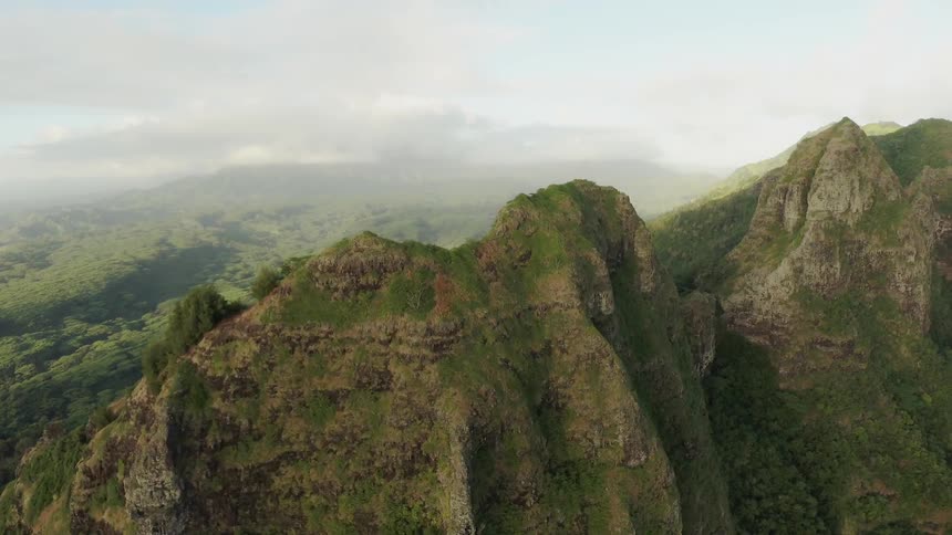 Moss and shrubs cover the stone mountains