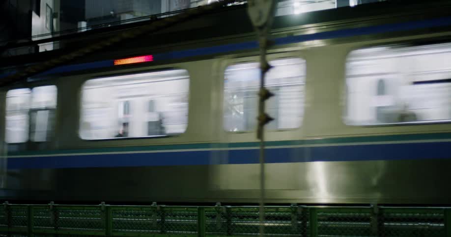 Train passes through a city at night