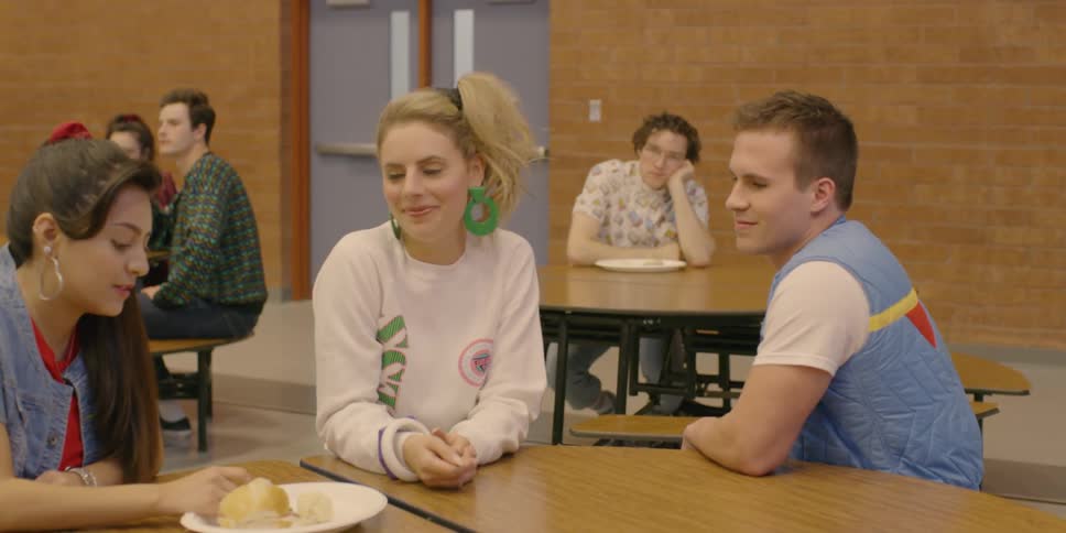 Teenagers sitting and talking in a cafeteria