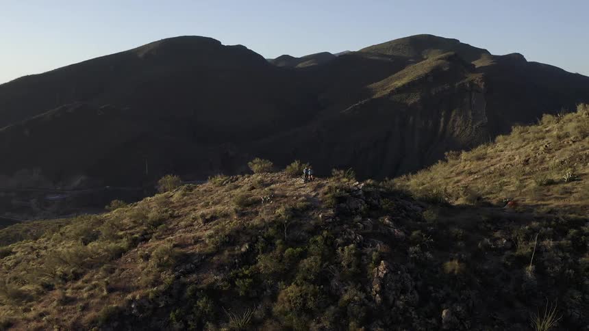 The hills are covered with bushes and grass