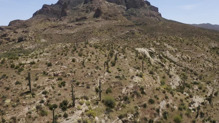 The hills lead to a large rock in the distance
