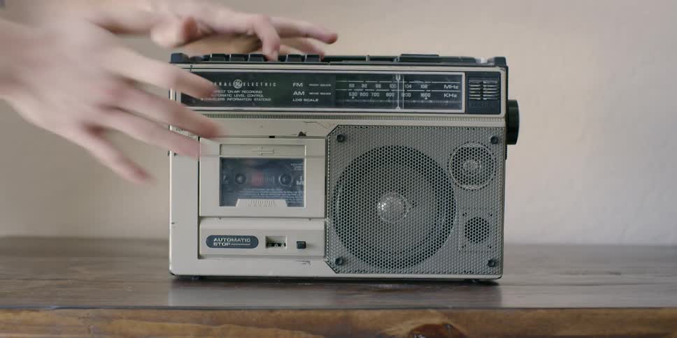 A person puts a tape in the radio