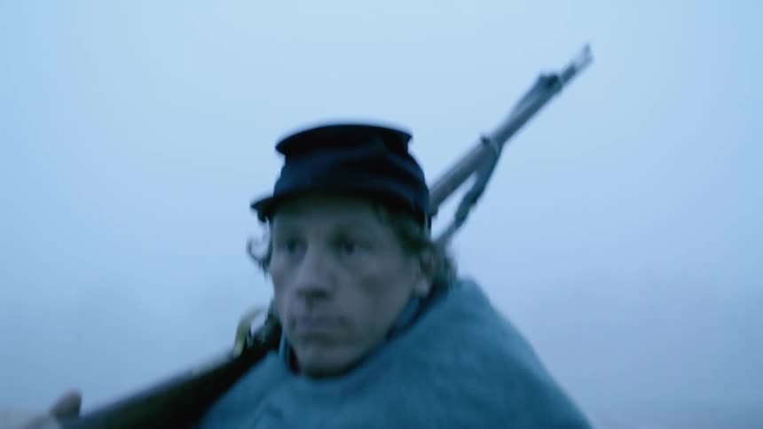 A soldier marches with his rifle