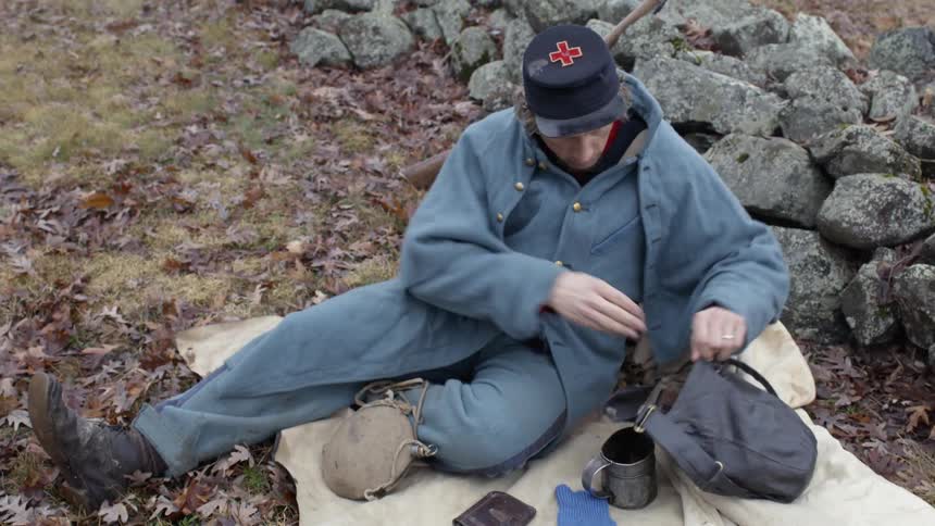 Man sits on a blanket with his provisions