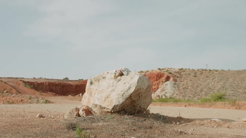A rock sits in the dirt canyon