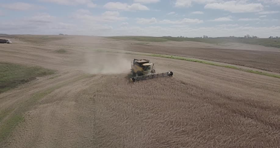 A tractor plows across the farmland