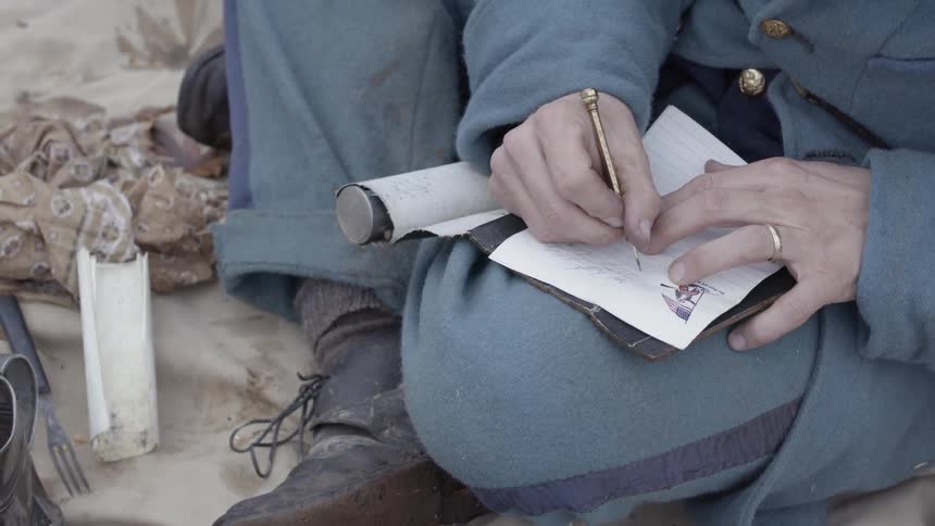 Man writes on a piece of paper