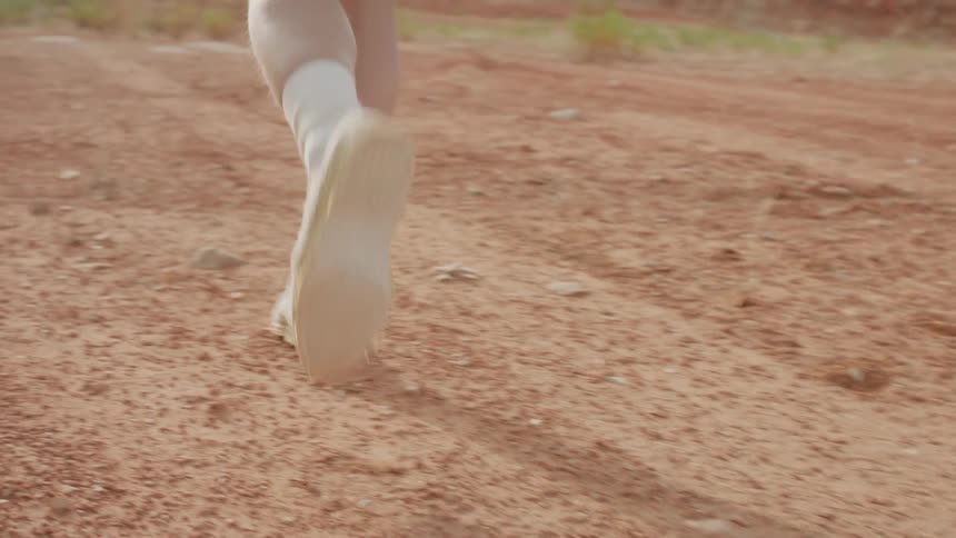 Person jogging along a dirt path